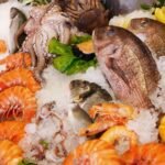 What is the reason for consuming seafood lower on the food chain?