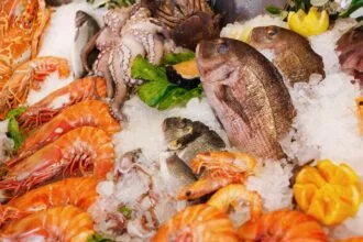What is the reason for consuming seafood lower on the food chain?